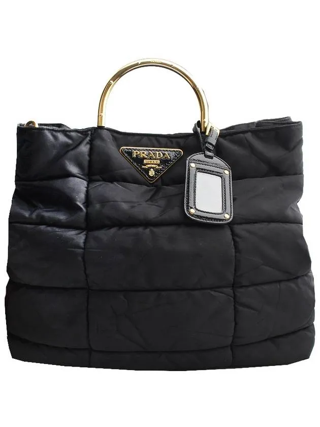 Black padded gold handle tote bag
